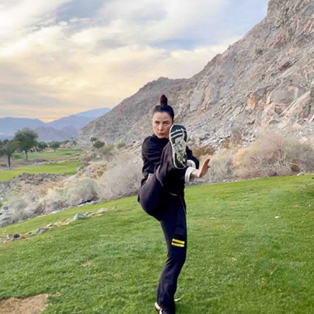 Girl in mountains kicking