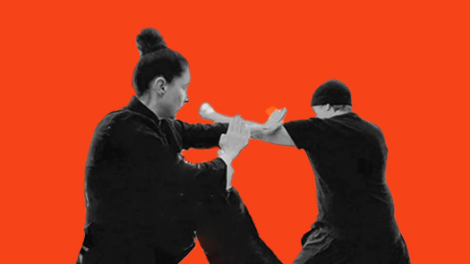 Sifu Kendra Mahon Kung Fu expert demonstrates bil sao and kick defense in wing chun with a partner