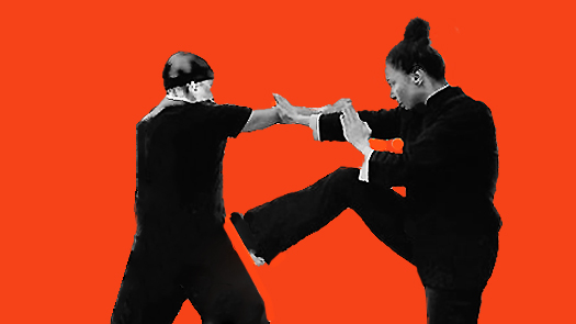 Sifu Kendra Mahon Kung Fu expert demonstrates bil sao and kick with a partner