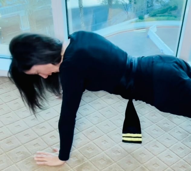 Female doing push ups in kung fu uniform