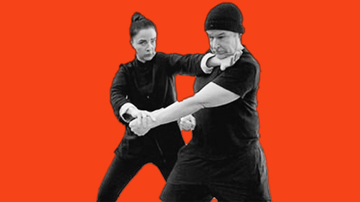Sifu Kendra Mahon Kung Fu expert demonstrates lop sao and chop to the neck with a partner