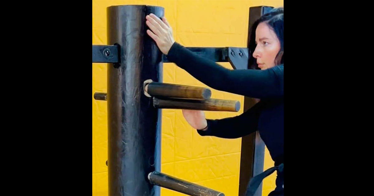 Sifu Kendra Mahon training on the Wing Chun Mook Yan Jong wooden dummy